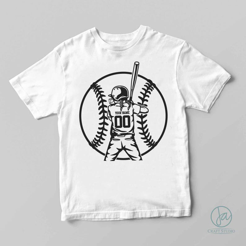 May include: Black and white graphic design of a softball player with a bat and ball on a white t-shirt. The player is wearing a helmet and has a number 00 on their jersey. The text "YOUR NAME" is above the number.