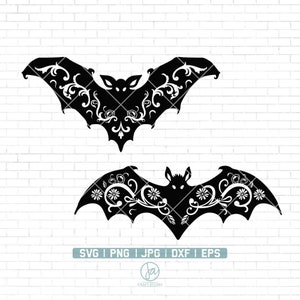 May include: Two black silhouette bats with intricate floral designs. The bats are facing opposite directions and have a stylized, whimsical look.