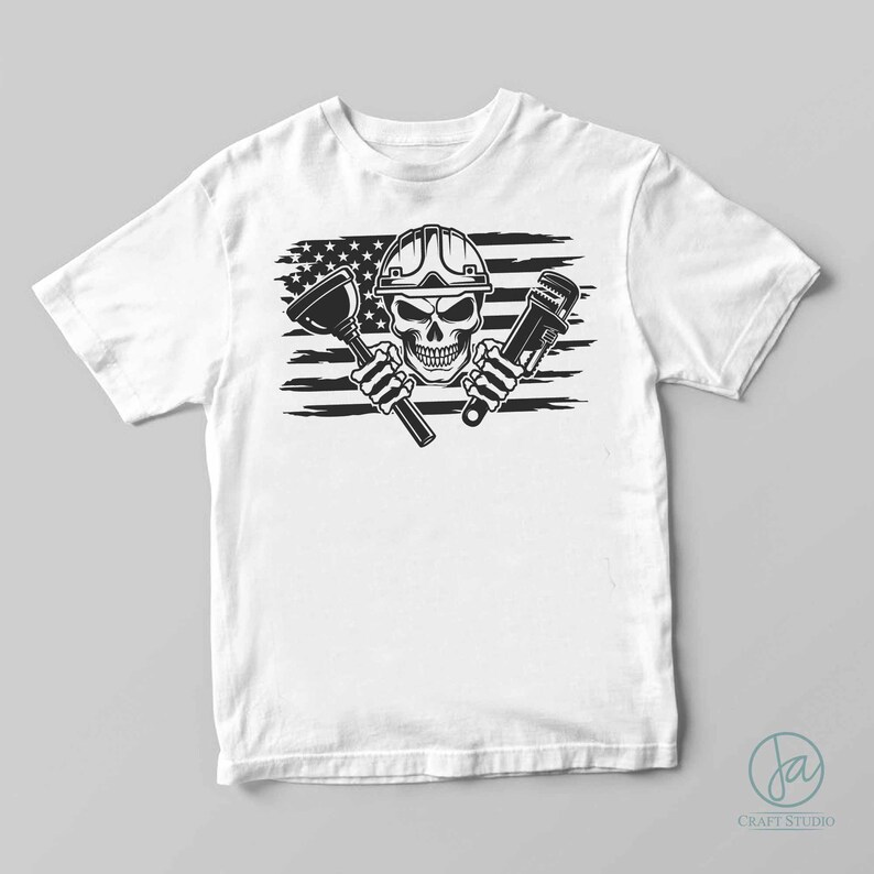 May include: White t-shirt featuring a black and white graphic of a skull wearing a hard hat, holding a plunger and a wrench, set against a stylized American flag background. The design is a bold, eye-catching illustration.