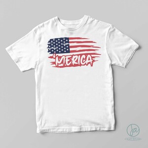 May include: White t-shirt with a distressed American flag graphic and the word 'MERICA' in blue lettering.