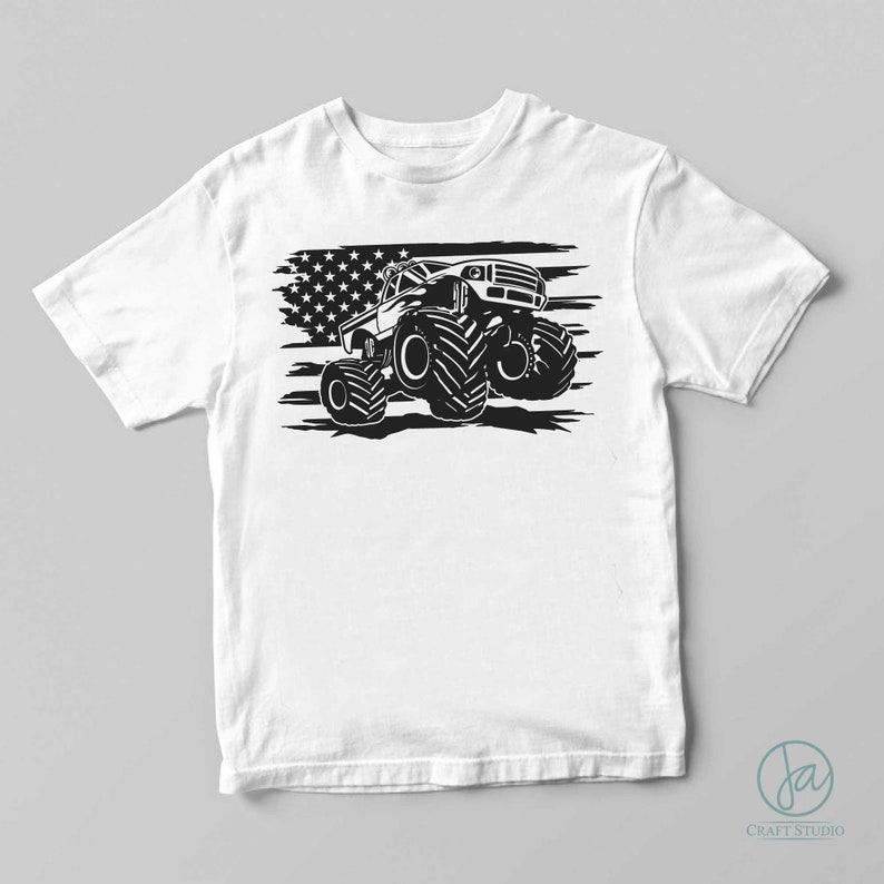 May include: A white t-shirt with a black and white graphic of a monster truck driving over an American flag.
