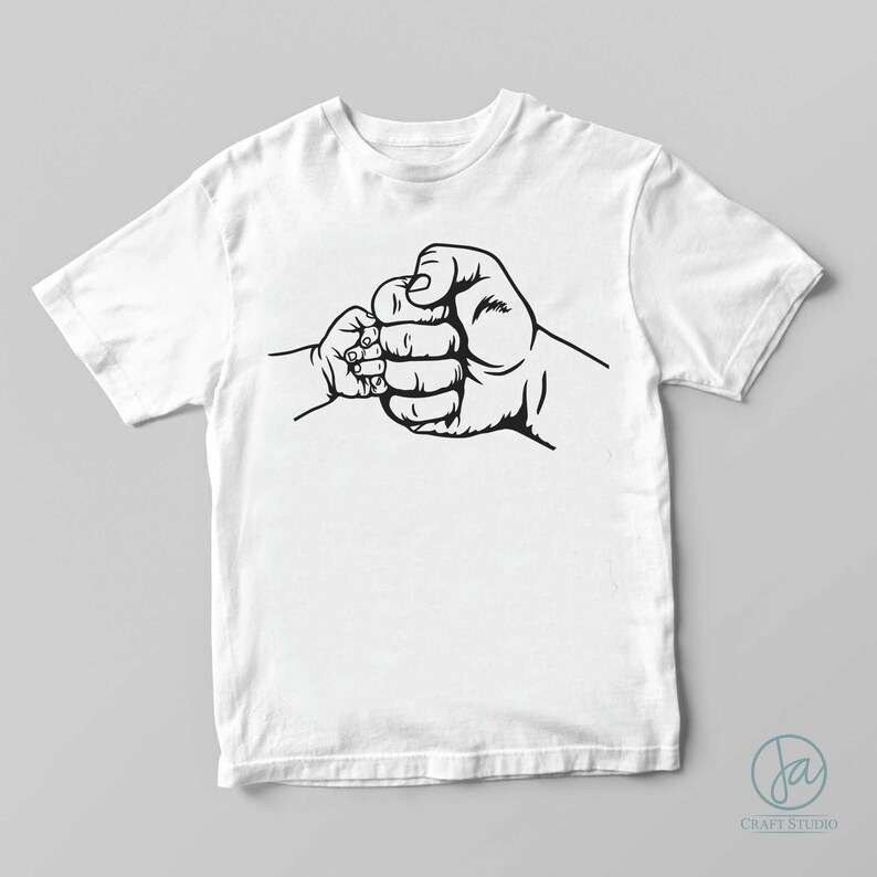 May include: A white t-shirt with a black graphic of two fists bumping, one larger than the other.