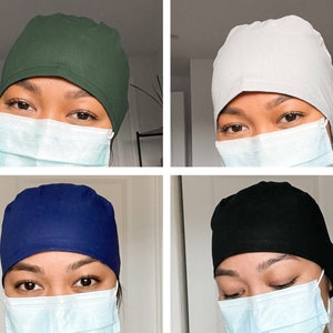 May include: Four different coloured scrub hats, each worn by a person with a face mask. The hats are green, white, navy blue, and black.