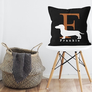 May include: Black and white throw pillow with a white dachshund silhouette and the letter "F" in brown. The pillow has the name "Frankie" printed in white below the dachshund.