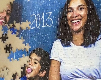 May include: A 500-piece jigsaw puzzle featuring a family portrait. The image shows a pregnant woman smiling, with a man and child partially visible. The background has the years 1991, 2013, and 2018 written on it.