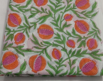 May include: White cotton fabric with a repeating pattern of green leaves and orange and pink pomegranates.