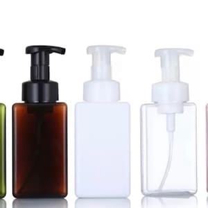 May include: Five plastic bottles with foam pump tops in different colours. The bottles are green, brown, white, clear and pink.