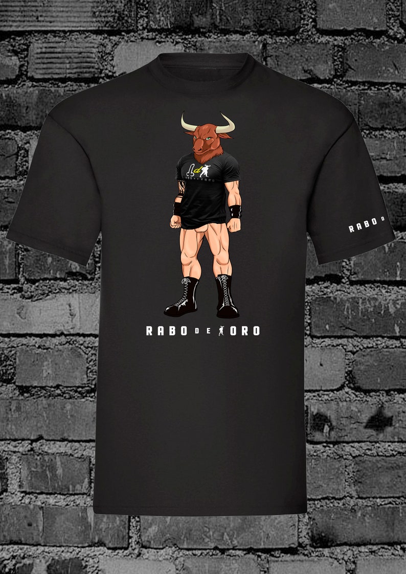 May include: Black t-shirt with a cartoon illustration of a bull-headed man wearing black boots and a black t-shirt with the text "Rabo de Oro" printed on the front. The text "Rabo de Oro" is also printed on the right sleeve of the shirt.