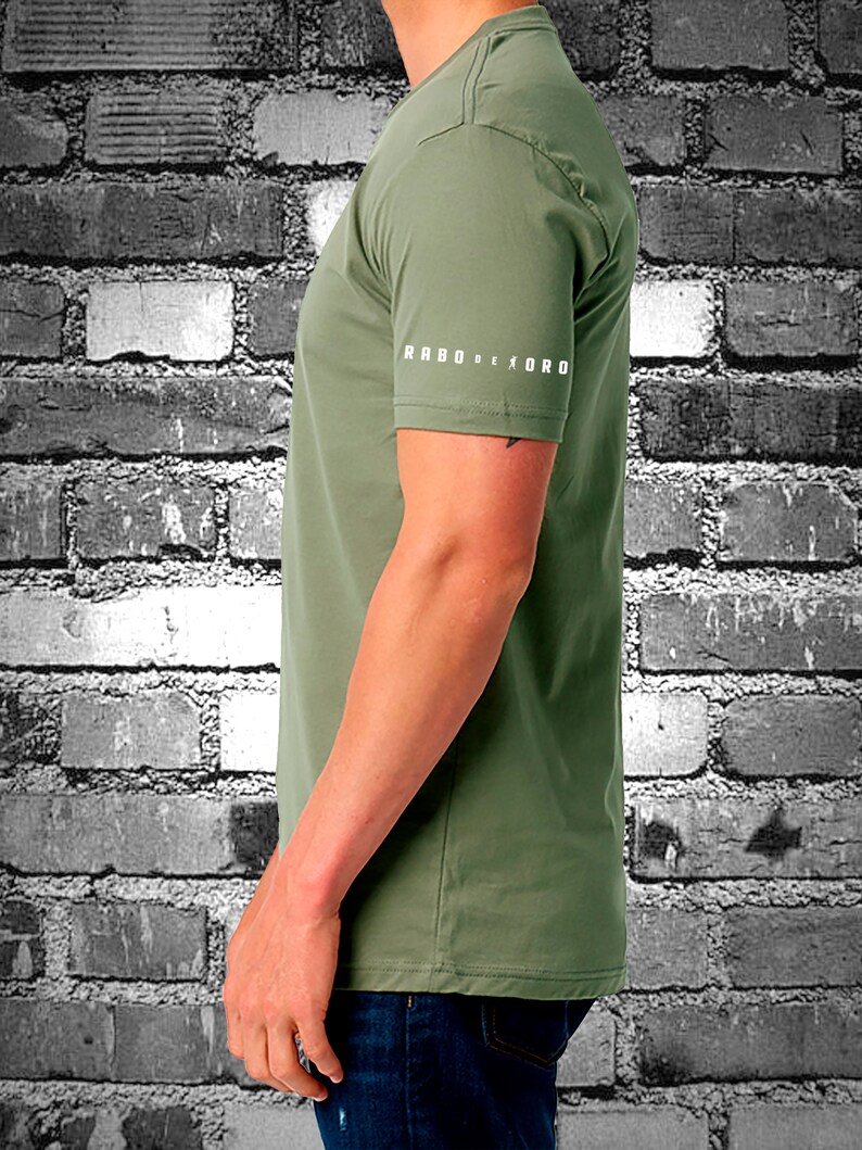 May include: A green short-sleeved t-shirt with the text "RABO DE TORO" printed on the sleeve.