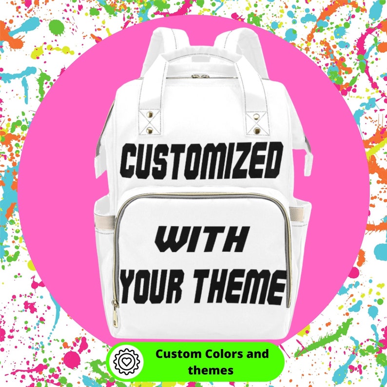 May include: White diaper bag with black text that reads "CUSTOMIZED WITH YOUR THEME". The bag is surrounded by colorful paint splatters.