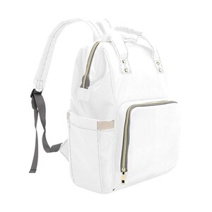 May include: A white diaper bag backpack with gold zippers and gray straps. The bag has multiple pockets and compartments.