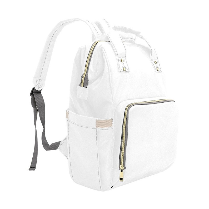 May include: A white diaper bag backpack with gold zippers and gray straps. The bag has multiple pockets and compartments.