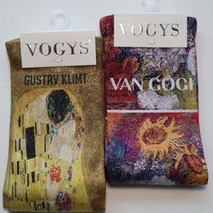 May include: Two pairs of socks with a gold glitter background. One pair features a painting by Gustav Klimt, "The Kiss", and the other pair features a painting by Van Gogh, "Sunflowers". The socks have the brand name "VOGYS" printed on the tags.