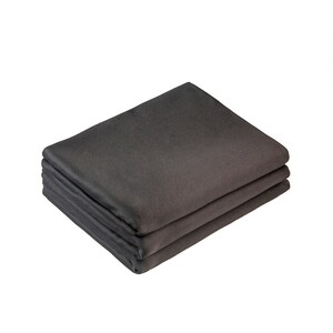 May include: A stack of three dark gray fabric placemats. The placemats are folded in half and stacked on top of each other.