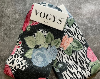 May include: Two pairs of black socks with a glittery finish. One pair features a floral and animal print, the other a zebra print. The socks have a white tag with the word "VOGYS" printed on it.