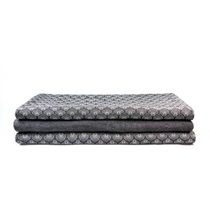 May include: Three folded fabric swatches in a geometric pattern. The top and bottom swatches are a white and gray pattern on a dark gray background. The middle swatch is a solid dark gray.