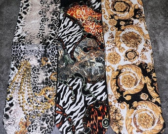 May include: Three pairs of socks with different patterns. The socks are black, white, and gold with animal prints and geometric designs. The socks are labeled "VOGYS".