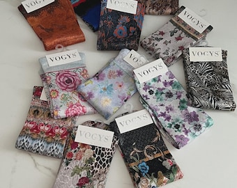 May include: A collection of patterned socks with the brand name "VOGYS" on each tag. The socks feature various designs, including floral, animal print, and abstract patterns. Colors include shades of brown, blue, pink, and green. Each pair is folded and displayed with a hanger.