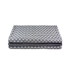 May include: A stack of three fabric panels with a geometric pattern of white stylized fans on a dark gray background.