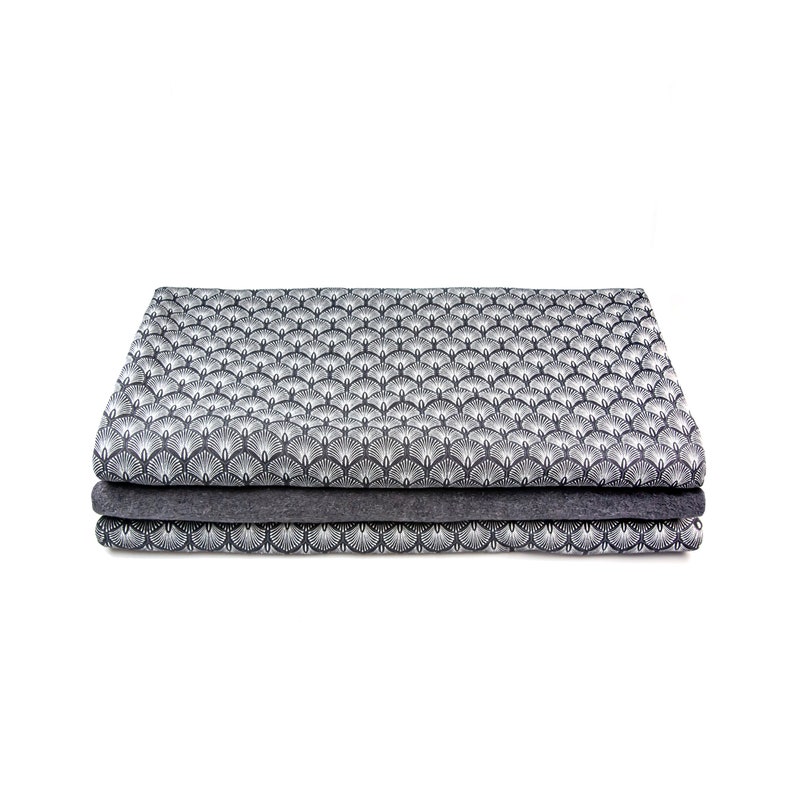 May include: A stack of three fabric panels with a geometric pattern of white stylized fans on a dark gray background.
