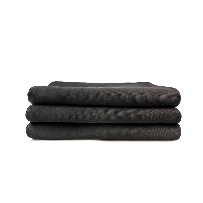 May include: A stack of three black fabric tablecloths folded neatly.