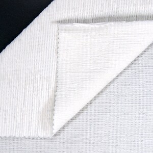 May include: Two pieces of white fabric with different textures. One piece has a ribbed texture, and the other has a fine, woven texture.
