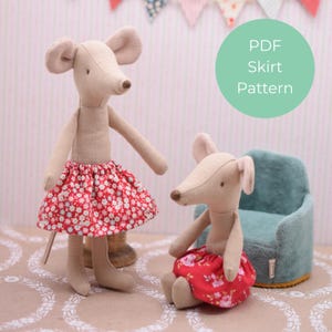 May include: Two beige mouse dolls wearing red floral skirts. One mouse is standing, the other is seated. The text "PDF Skirt Pattern" is in a green circle in the background. The dolls are on a patterned surface.
