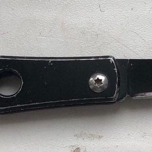 May include: A black pocket knife with a silver screw and a key ring. The knife has three holes in the handle.