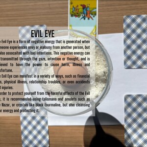 May include: A clear glass bowl filled with white salt and a single brown egg, surrounded by four tarot cards with blue and white plaid backs and one card showing a figure, with text overlay explaining the concept of the Evil Eye in detail.