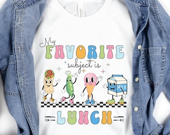 May include: White t-shirt with a graphic of cartoon food characters and the text "My Favorite Subject is Lunch".