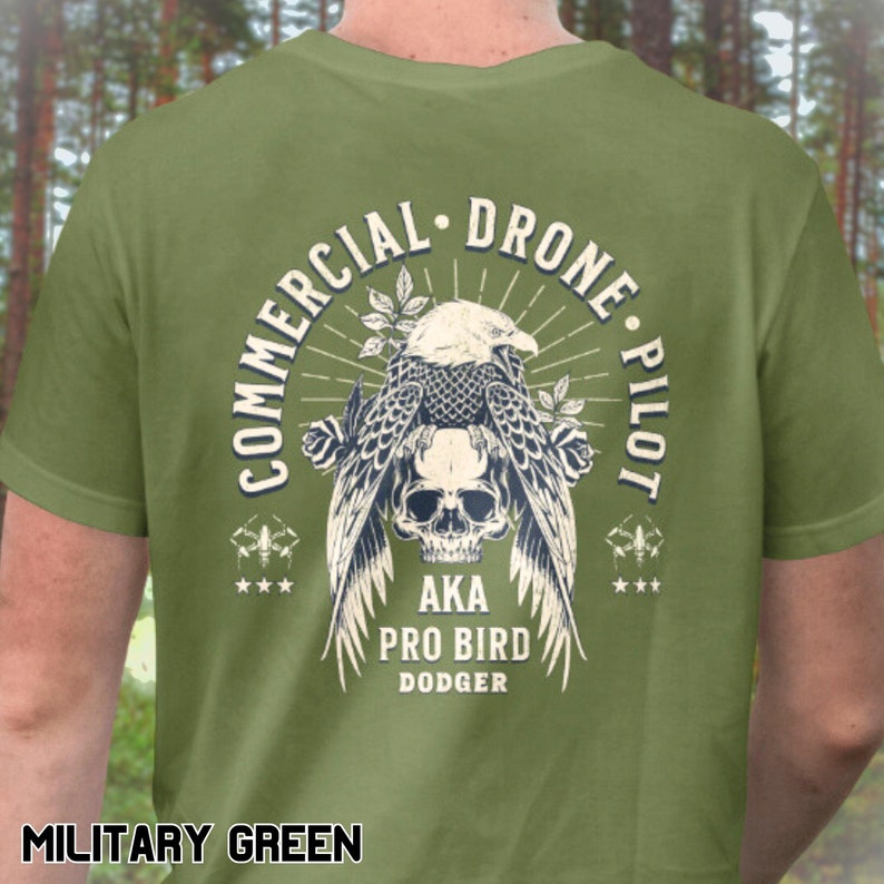 May include: A green t-shirt with a graphic of a skull with wings and the text "Commercial Drone Pilot AKA Pro Bird Dodger".