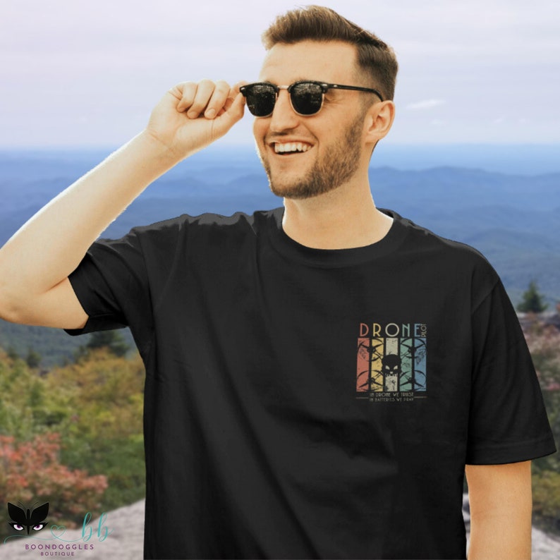 May include: A black t-shirt with a vintage-style graphic of a drone with the text "Drone Life: We don't just fly, we chase batteries by day".