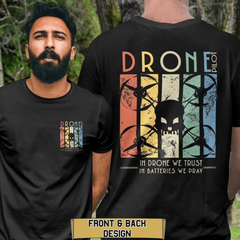 May include: Black t-shirt with a vintage-style graphic of a drone with a skull in the center. The text "Drone Pilot" is at the top and "In Drone We Trust In Batteries We Pray" is at the bottom.