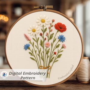 May include: A digital embroidery pattern featuring a floral bouquet. The design includes white daisies, a red poppy, blue and pink flowers, and green leaves, all within a wooden embroidery hoop. The text "Digital Embroidery Pattern" is visible.