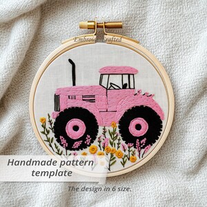 May include: Embroidered hoop art featuring a pink tractor with black wheels, surrounded by embroidered flowers. The text "Handmade pattern template" is visible. The design is set in a wooden hoop.