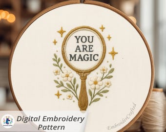 May include: A digital embroidery pattern in a wooden hoop. The design features a mirror with the words "YOU ARE MAGIC" surrounded by flowers and stars. The text "Digital Embroidery Pattern" is also visible.
