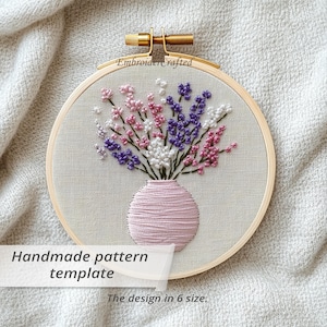 May include: Embroidered floral design in a wooden hoop. The embroidery features a pink vase filled with white, pink, and purple flowers. The text "Handmade pattern template" and "The design in 6 size" are visible.