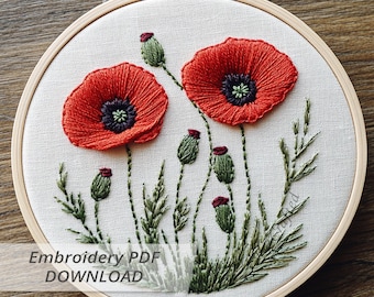 May include: Hand-stitched embroidery art featuring two vibrant red poppies with dark centers, surrounded by green buds and foliage. The floral design is set within a wooden embroidery hoop, showcasing detailed thread work. The text "Embroidery PDF DOWNLOAD" is visible.