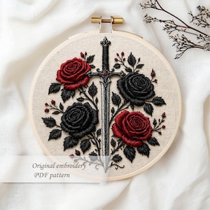 May include: Embroidered artwork in a wooden hoop features a sword design with red and black roses. The text "Original embroidery PDF pattern" is visible. The embroidery is set against a neutral fabric background.