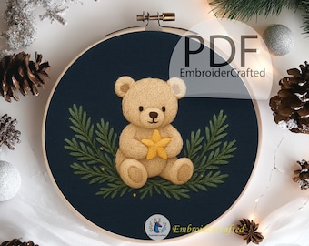 May include: A circular embroidery hoop with a tan teddy bear holding a yellow star, set against a navy blue backdrop with green foliage. The text "PDF EmbroiderCrafted" is visible. The design is framed in a wooden hoop.