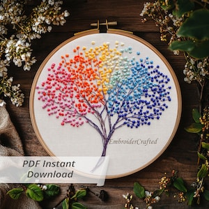 May include: A colorful embroidered tree design in a wooden hoop. The tree features branches with red, orange, yellow, white, blue, and purple bead-like details. The text "PDF Instant Download" is visible.