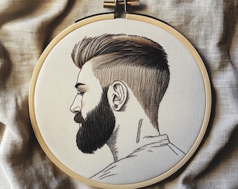 May include: Embroidery hoop art featuring a detailed profile of a man with a full beard and stylish haircut. The artwork is rendered in shades of brown and black thread on a cream-colored fabric, set within a wooden hoop.