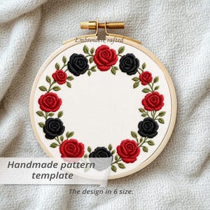 May include: An embroidery hoop featuring a floral design of red and black roses with green leaves. The text "Handmade pattern template" and "The design in 6 size" are visible on the image. The hoop is made of wood.