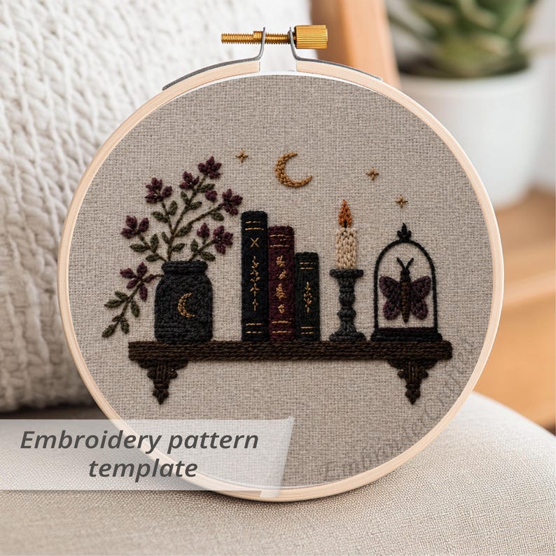 May include: An embroidery hoop with a detailed design featuring a shelf with books, a vase of flowers, a candle, and a butterfly in a cloche. The text "Embroidery pattern template" is at the bottom.