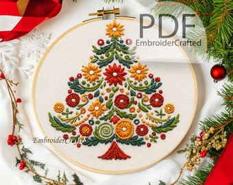 May include: A hand-stitched Christmas tree embroidery in a wooden hoop. The tree is adorned with red, yellow, and green floral designs. The text "PDF EmbroiderCrafted" is visible. Festive greenery and red ribbon surround the embroidery.