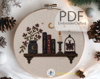 May include: Embroidered hoop art featuring a shelf with books, a candle, and a butterfly in a glass dome. A vase with flowers and a crescent moon are also included. The text "PDF EmbroiderCrafted" is visible. The color palette includes shades of brown, black, and cream.