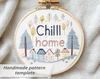 May include: A round embroidery hoop with a stitched design. The design features the words "Chill home" in blue and pink, with embroidered trees and houses. The text "Handmade pattern template" is also included.