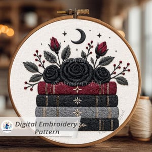 May include: An embroidery hoop featuring a floral design with black roses, red buds, and a crescent moon. The design is above a stack of embroidered books. The text "Digital Embroidery Pattern" is visible.