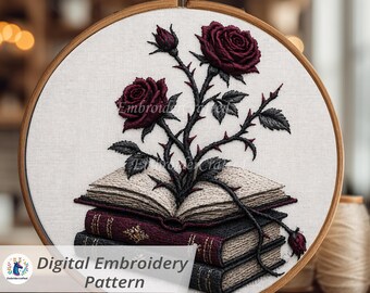 May include: An embroidery hoop featuring a digital embroidery pattern. The design showcases a stack of books with a rose bush growing from them. The roses are a deep burgundy color, and the text "Digital Embroidery Pattern" is visible.