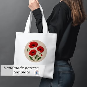 May include: White tote bag featuring an embroidered design of red poppies with black centers and green stems and leaves, set within a beige circle. The bag has the text "Handmade pattern template".